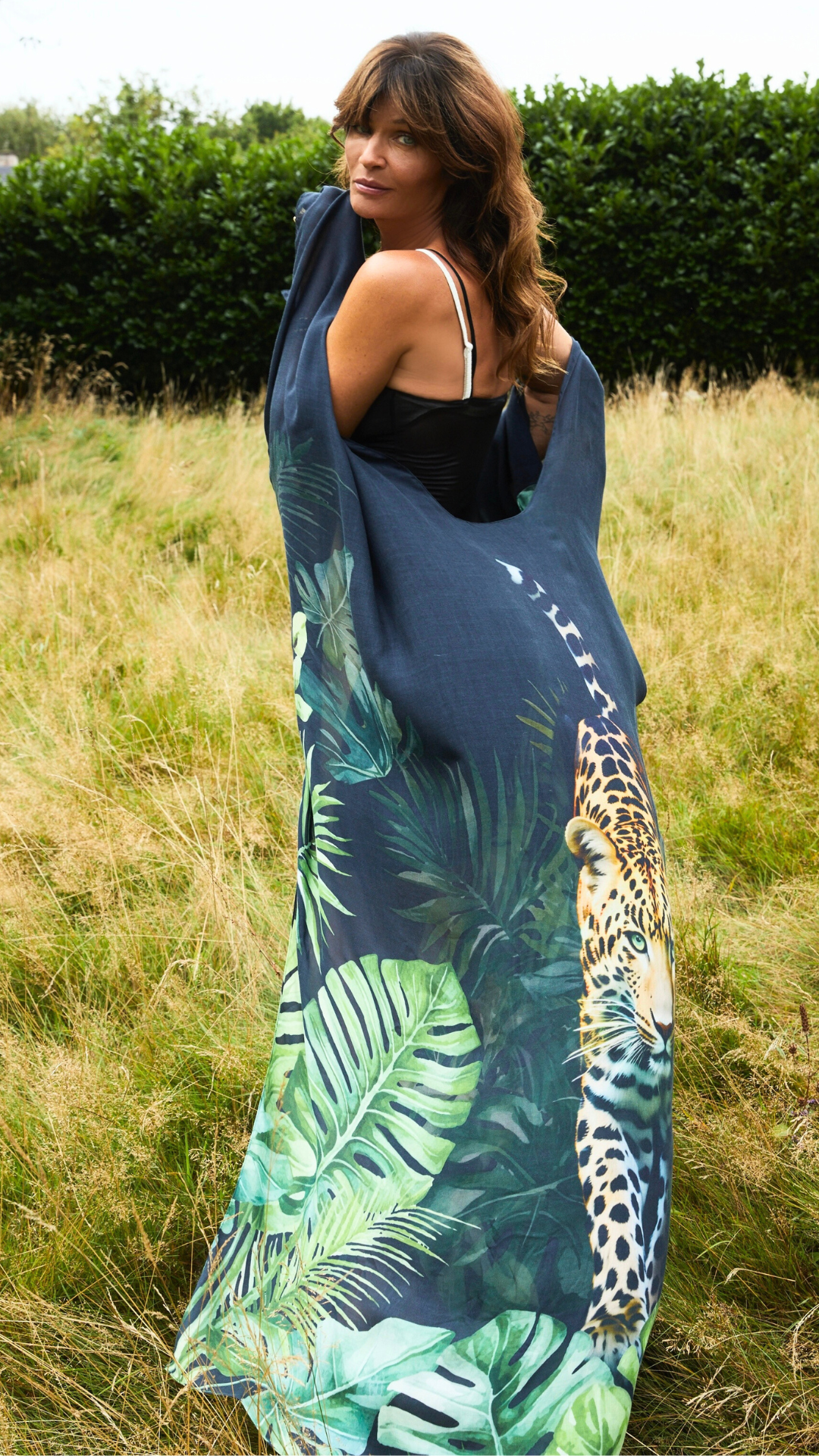 Helena Christensen wearing the blue jaguar-print resort wear design